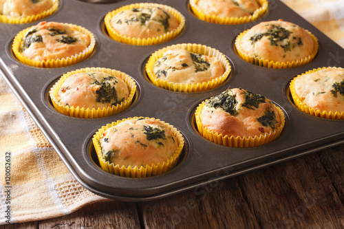 muffins with fresh spinach and feta cheese close up in baking dish. Horizontal 