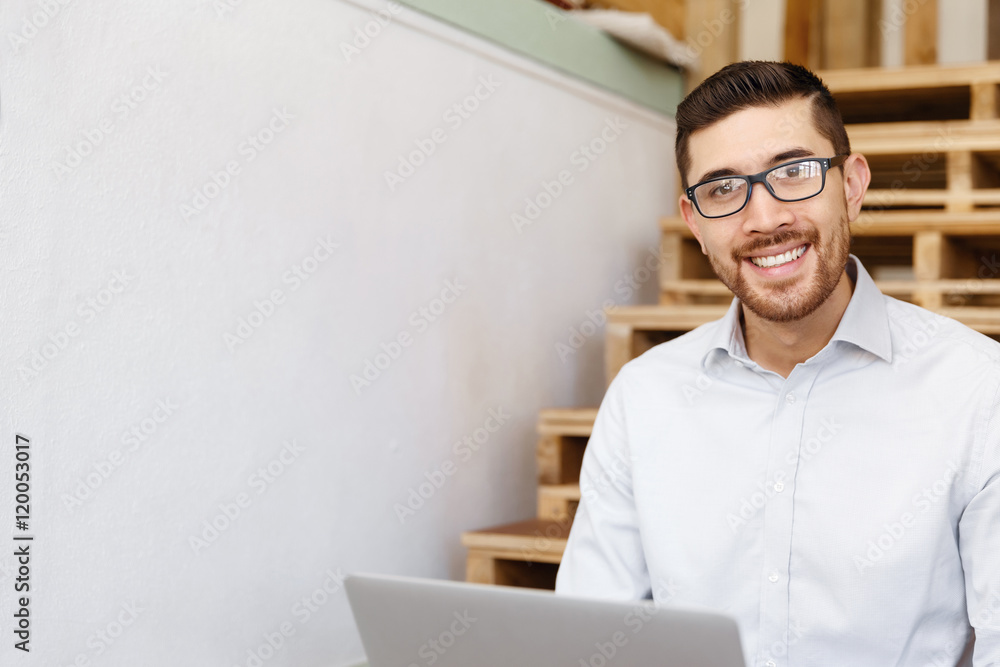 Portrait of young man sitting at the stairs in office Portrait of young man sitting at the stairs in office