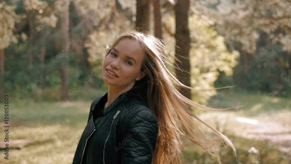 Portrait of happy female model in autumn forest. Student walking after lessons and dancing Portrait of happy female model in autumn forest. Student walking after lessons and dancing