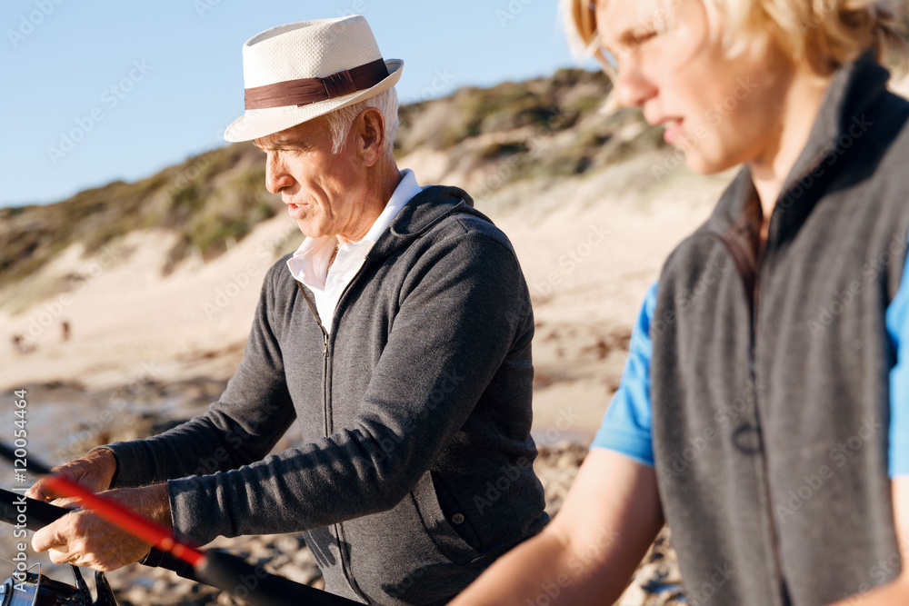 Senior man fishing with his grandson