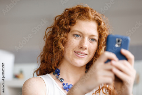 Happy beautiful young businesswoman using smart phone smiling