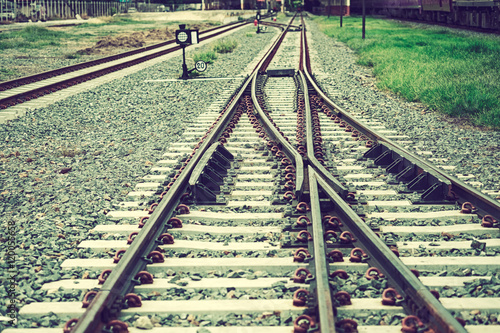 Two railways tracks merge close up.Vintage tone photo