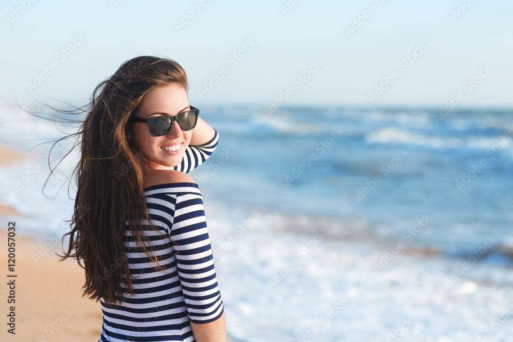 Beautiful girl relaxing and smiling outdoor at summer beach