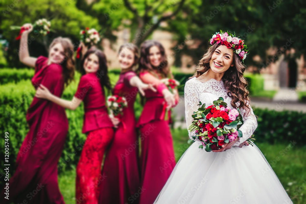 Bride with bridesmaids in a park Bride with bridesmaids in a park