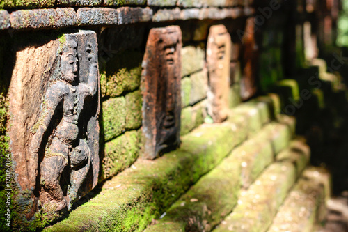Figurines or Statuettes sculptured on the base of the complex wall with moss surrounding it at Dambegoda Bodhisattva Statue complex in Dambegoda,  near Okkampitiya in Uva Province, Sri Lanka   photo