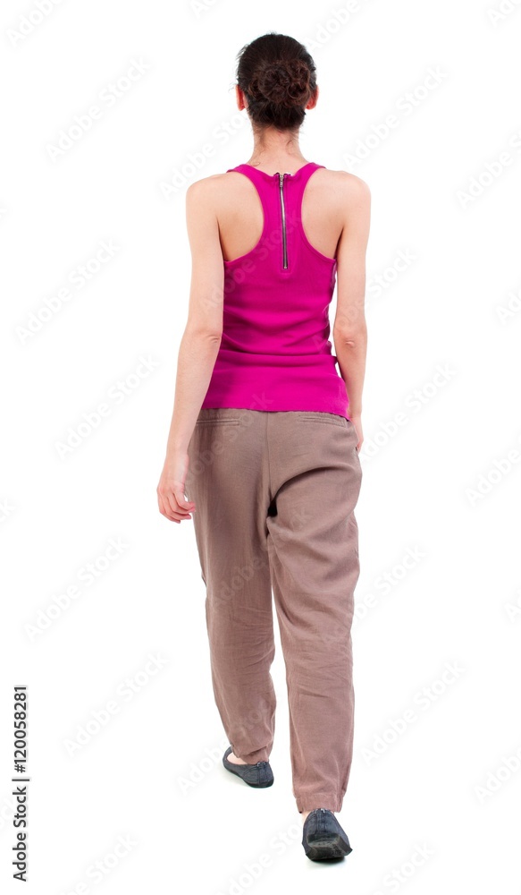 back view of walking curly woman. dark girl slowly moving forward. back view of walking curly woman. dark girl slowly moving forward.
