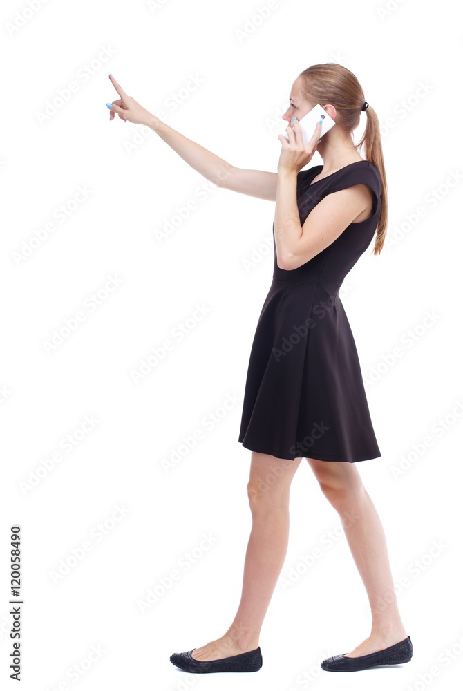 side view of walking woman. Rear view people collection. Isolated over white background. Blonde in a short black dress is divided gossip on the phone side view of walking woman. Rear view people collection. Isolated over white background. Blonde in a short black dress is divided gossip on the phone