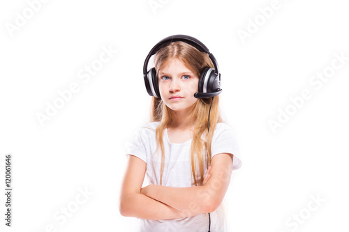 Young girl listening to music with headphones over white