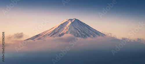 Mount Fuji enshrouded in clouds with clear sky from lake kawaguchi, Yamanashi, Japan