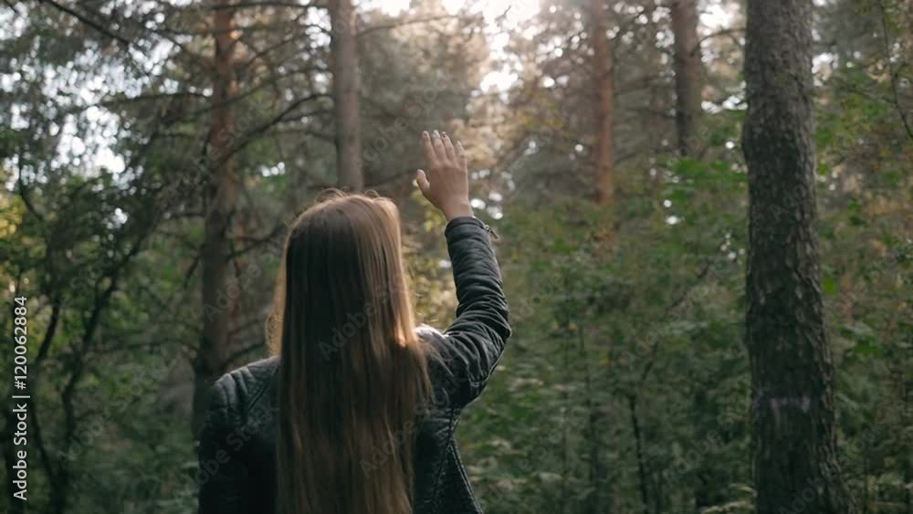 Girl throwing arms in Autumn in slow motion, smiling into the camera. Fashion pose in forest, smiling attractive brunette on a walk Girl throwing arms in Autumn in slow motion, smiling into the camera. Fashion pose in forest, smiling attractive brunette on a walk
