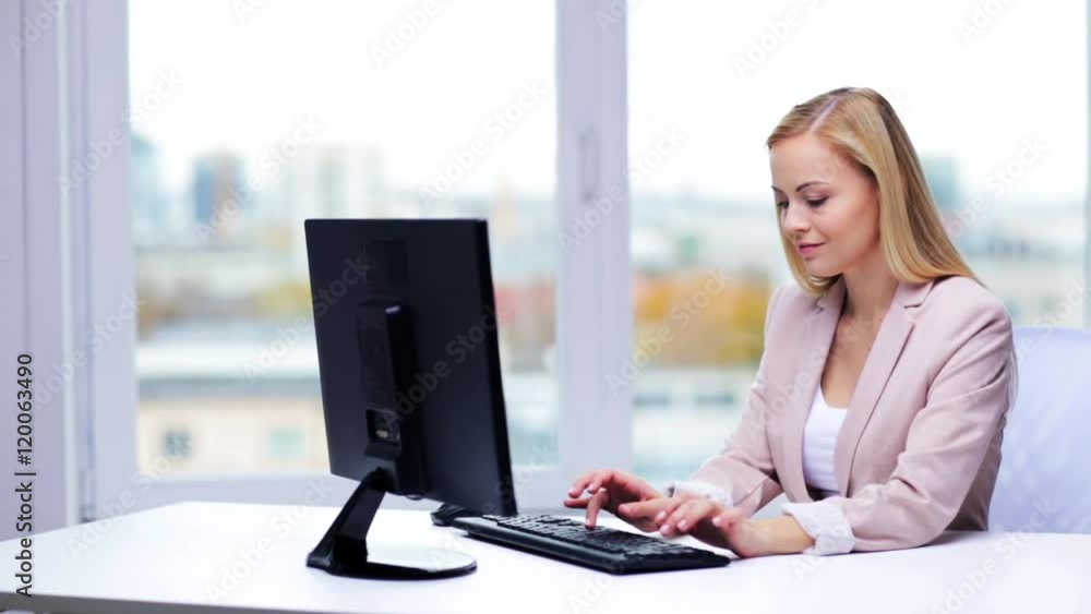 young businesswoman with computer typing at office
