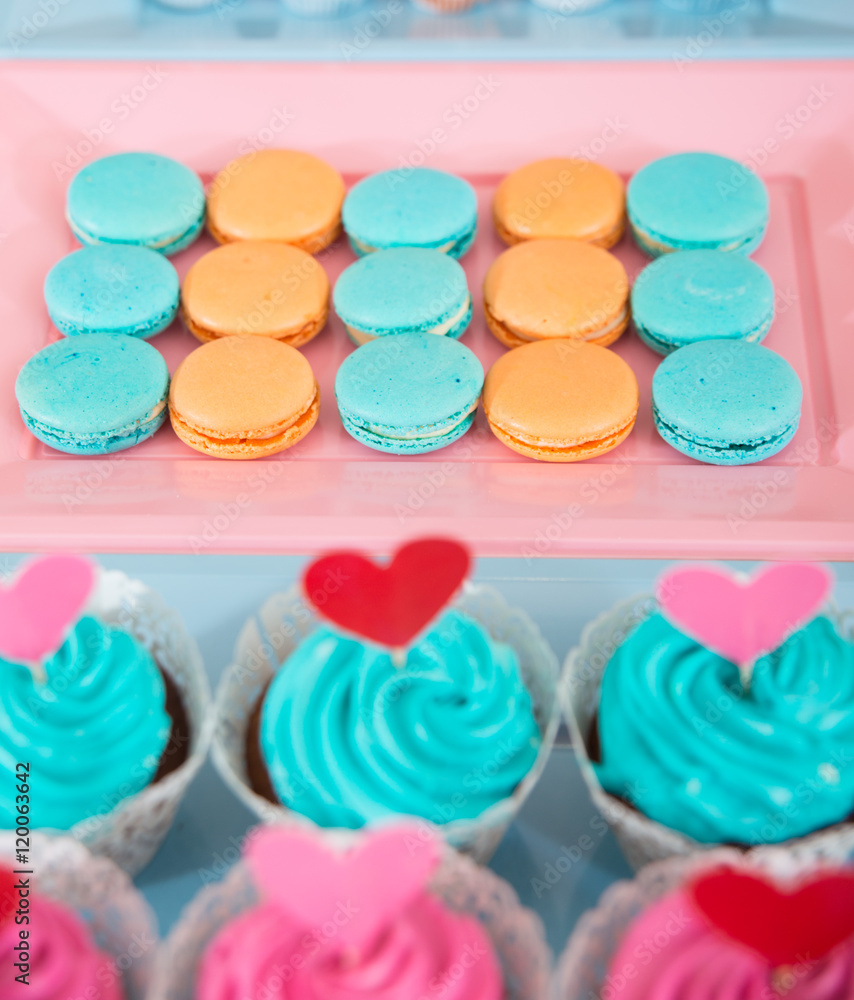 Wedding decorations with different sweets: macarons, cupcakes an Wedding decorations with different sweets: macarons, cupcakes an
