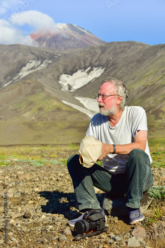 Rest of the researcher/Photo-portrait of a researcher and a volcanologist at the background of the volcano Avacha