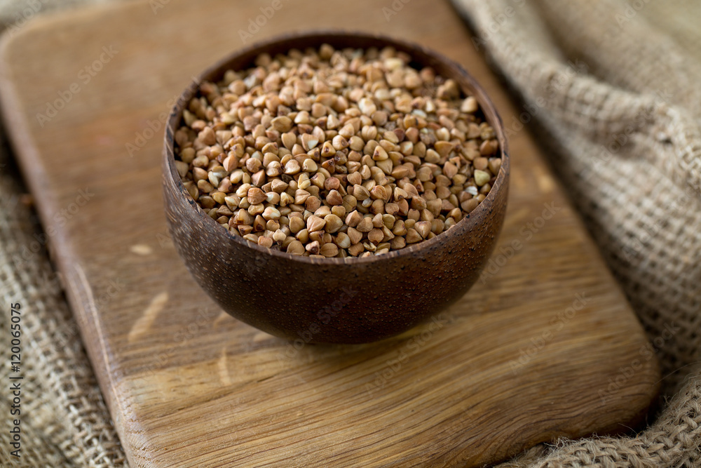 buckwheat groats on wooden surface buckwheat groats on wooden surface