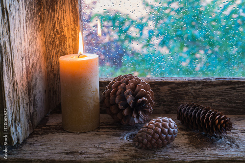 Canvas Print lit candle and pine cones