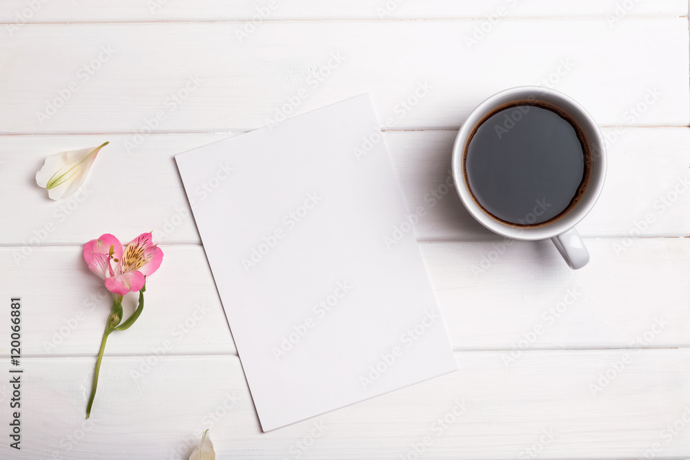 Blank paper, coffee and flower on white table Blank paper, coffee and flower on white table
