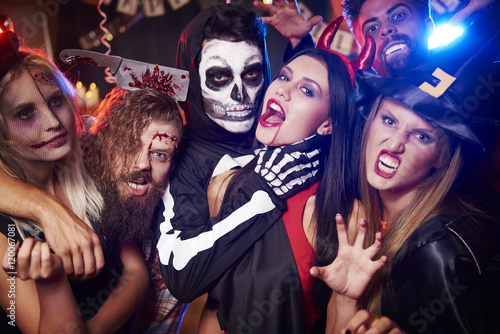 Spooky costumes of party people.