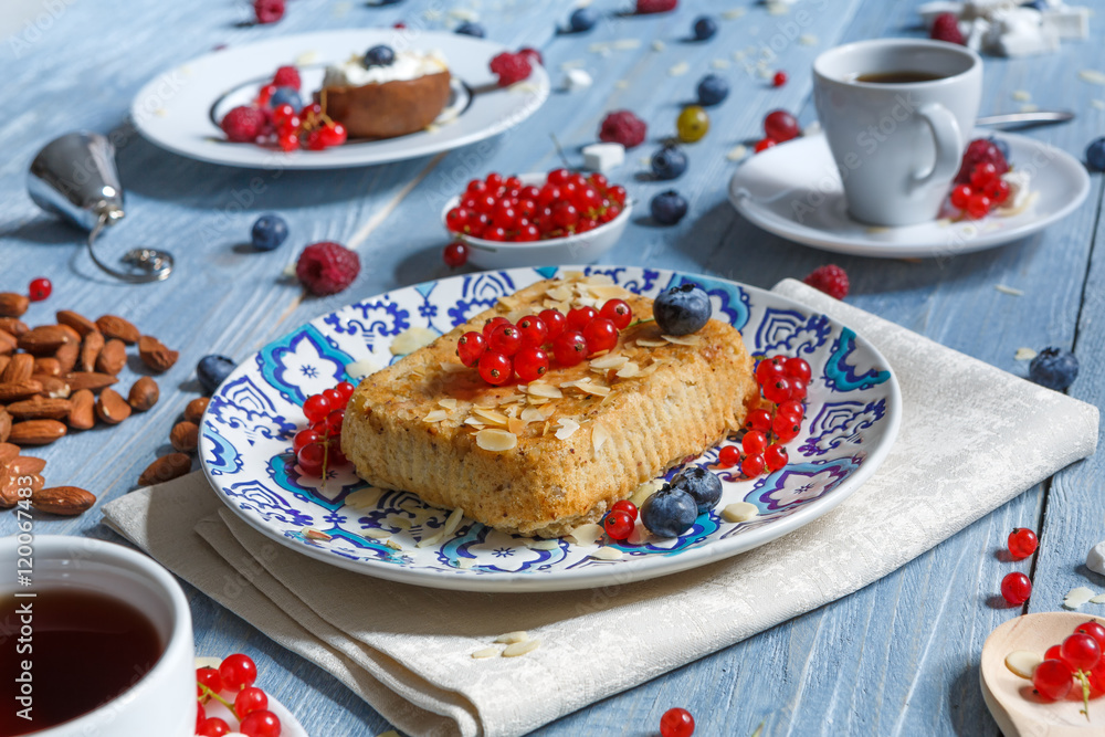 Pastry pie, tea, coffee and berries at blue rustic wood Pastry pie, tea, coffee and berries at blue rustic wood