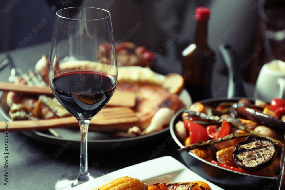 Glass of wine and grilled vegetables on served table Glass of wine and grilled vegetables on served table