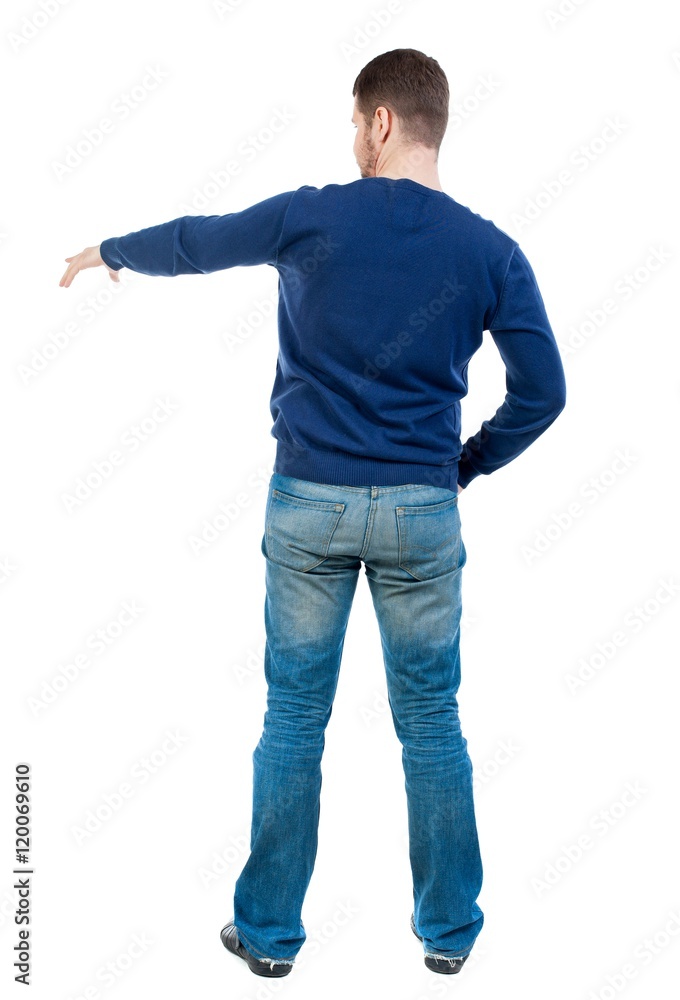 Back view of pointing business man. . bearded man in blue pullover shows his hand to the side. Back view of pointing business man. . bearded man in blue pullover shows his hand to the side.