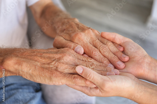 Old male and young female hands, closeup