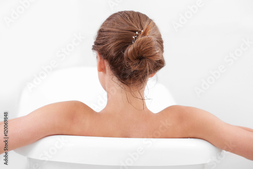 Girl relaxing in bathtub