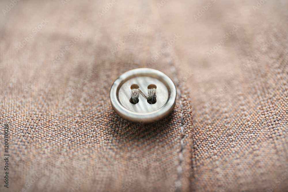Grey button on clothes, close up Grey button on clothes, close up