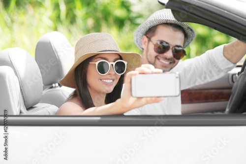 Couple taking selfie on roa...