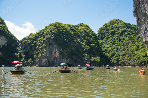 Tourists asia traveling beautiful view in the Halong Bay Vietnam landscape ocean and limestone mountain on blue sky background.