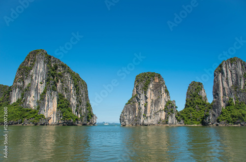 Beautiful travel view in the Halong Bay Vietnam landscape ocean and limestone mountain on blue sky background.