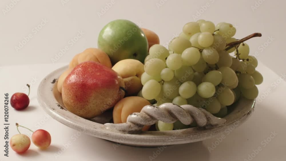 turning plate with fruit on white background, apear, grapes, peaches, apple turning plate with fruit on white background, apear, grapes, peaches, apple