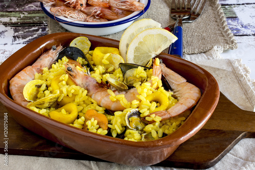 Delicious meal with shrimps and yellow rice photo