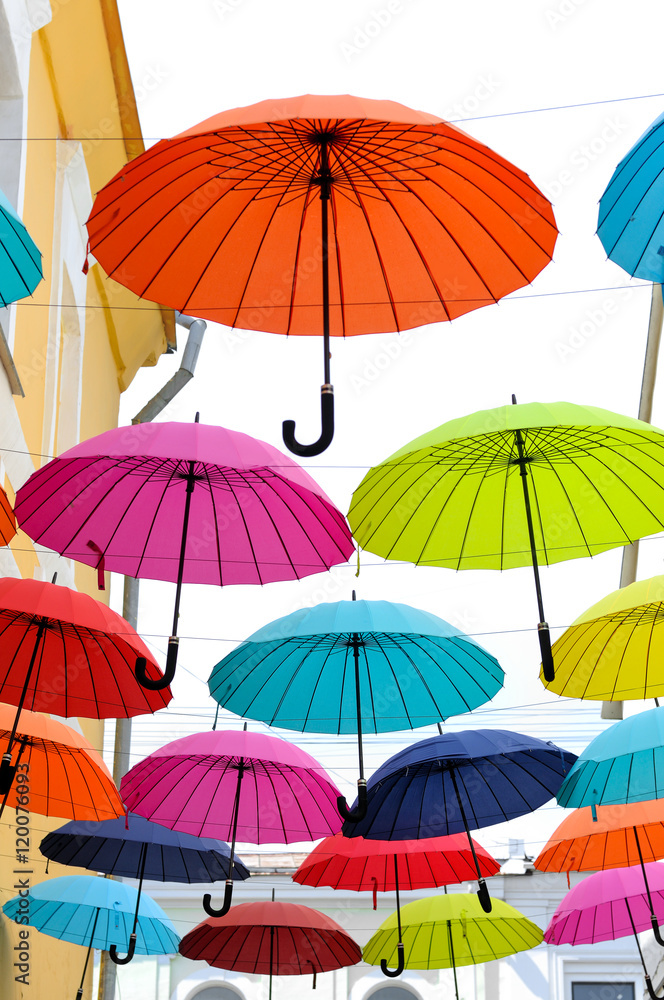 Multicolored umbrellas hanging on strings