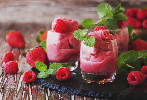 frozen yogurt, sorbet with strawberries, raspberries and mint, selective focus