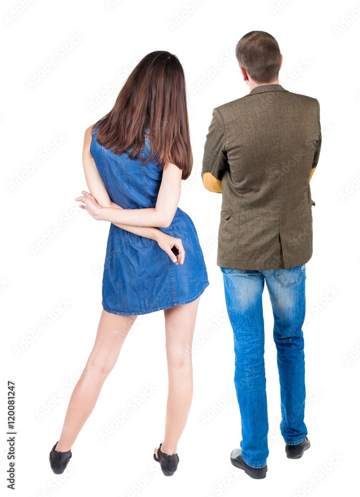 Back view of young couple man and woman hug and look into the distance. beautiful friendly girl and guy together. Rear view. Isolated over white background. young woman holds the hand of her husband Back view of young couple man and woman hug and look into the distance. beautiful friendly girl and guy together. Rear view. Isolated over white background. young woman holds the hand of her husband
