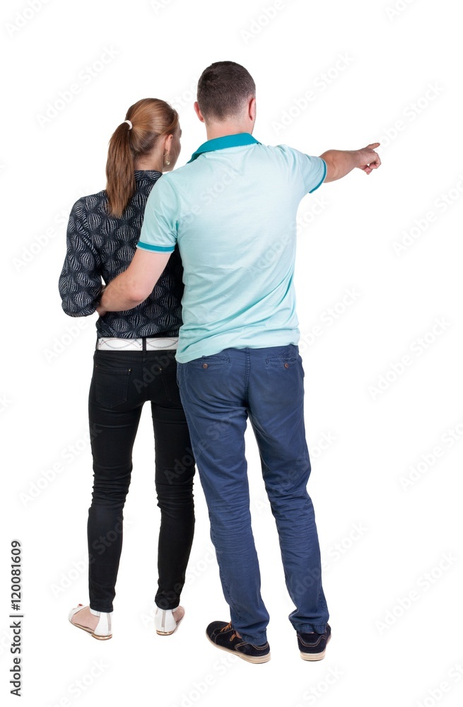 young couple pointing. Back view. Rear view people collection. backside view of person. Isolated over white background. young couple pointing. Back view. Rear view people collection. backside view of person. Isolated over white background.