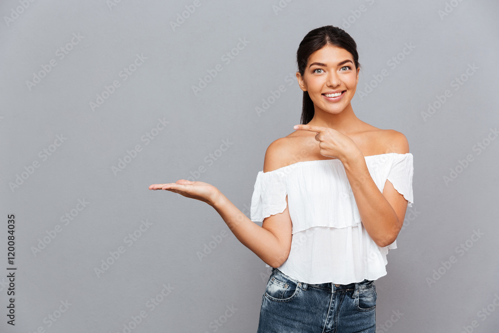 Portrait of a pretty girl holding copyspace on the palm Portrait of a pretty girl holding copyspace on the palm