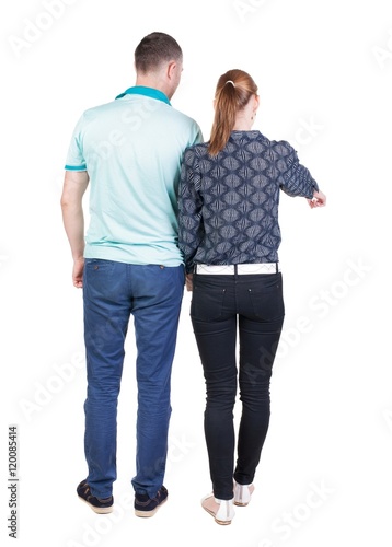 young couple pointing. Back view. Rear view people collection. backside view of person. Isolated over white background.