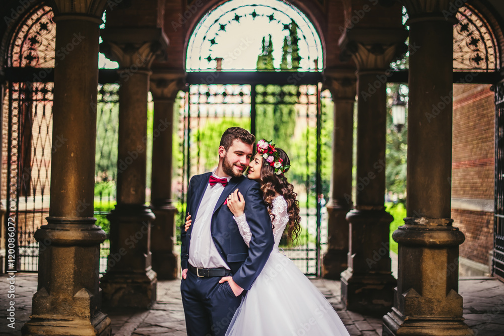 Groom and bride near the columns