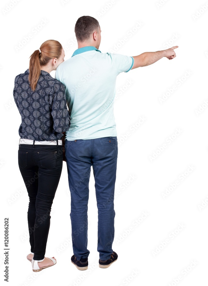 young couple pointing at wal Back view woman and man . Rear view people collection. backside view of person. Isolated over white background. young couple pointing at wal Back view woman and man . Rear view people collection. backside view of person. Isolated over white background.
