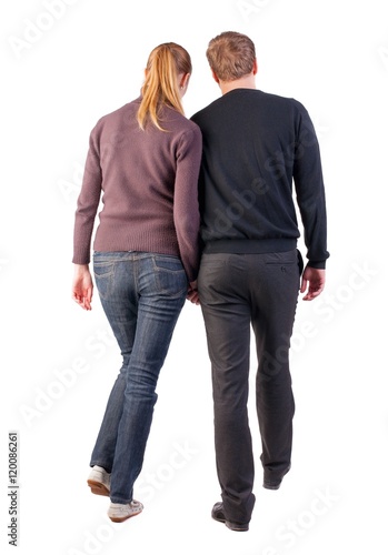 Back view of walking young couple (man and woman). going beautiful friendly girl and guy in shorts together. Rear view people collection. backside view of person. Isolated over white background