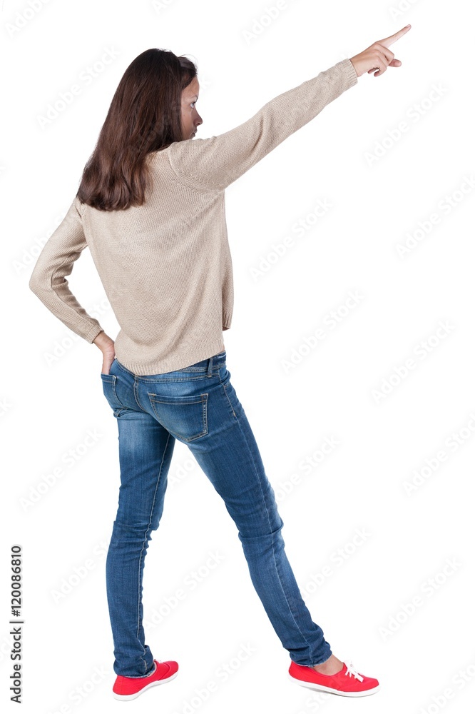 Back view of pointing woman. beautiful brunette girl in jeans. Rear view people collection. backside view of person. Isolated over white background. Back view of pointing woman. beautiful brunette girl in jeans. Rear view people collection. backside view of person. Isolated over white background.