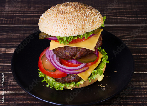 Delicious Burger With Beef, Tomato, Cheese, Lettuce and Onion photo