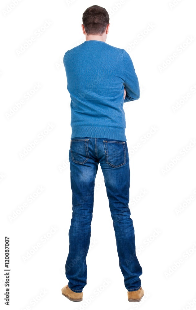 Back view of handsome man in blue pullover looking up. Standing young guy in jeans. Rear view people collection. backside view of person. Isolated over white background. Back view of handsome man in blue pullover looking up. Standing young guy in jeans. Rear view people collection. backside view of person. Isolated over white background.