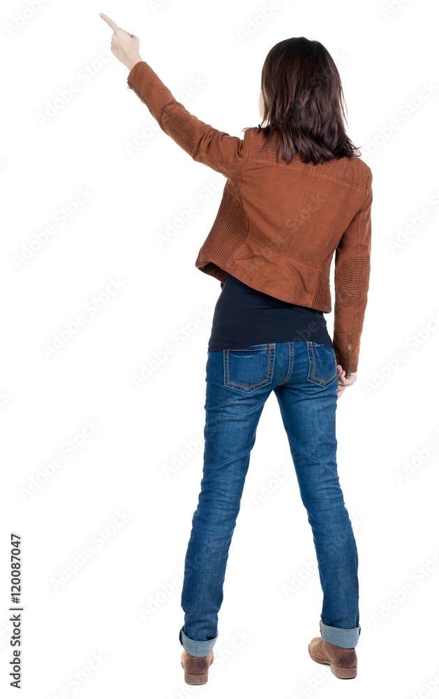 Back view of pointing woman. beautiful brunette girl in brown jacket. Rear view people collection. backside view of person. Isolated over white background. Back view of pointing woman. beautiful brunette girl in brown jacket. Rear view people collection. backside view of person. Isolated over white background.