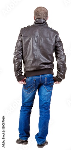 Back view of handsome man in jacket looking up. Standing young guy in jeans and jacket. Rear view people collection. backside view of person. Isolated over white background.