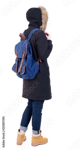 Back view woman in winter jacket with a backpack looking up. Standing young girl in parka. Rear view people collection. backside view of person. Isolated over white background.