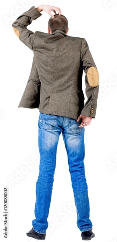 Back view of thinking business man in jacket . gesticulating young guy in jeans and suit jacket with patches on the sleeves. Rear view people collection.  backside view of person.  Isolated over white photo