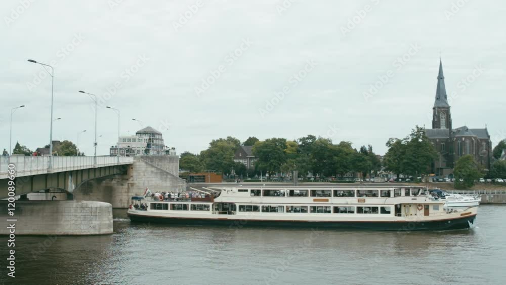 WIDE FIXED Long passenger ship on a lake Meuse, Maastricht, Netherlands. 4K UHD WIDE FIXED Long passenger ship on a lake Meuse, Maastricht, Netherlands. 4K UHD
