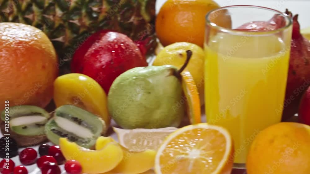 Tracking camera shot of variety of fresh fruits with wet skin on white background Tracking camera shot of variety of fresh fruits with wet skin on white background